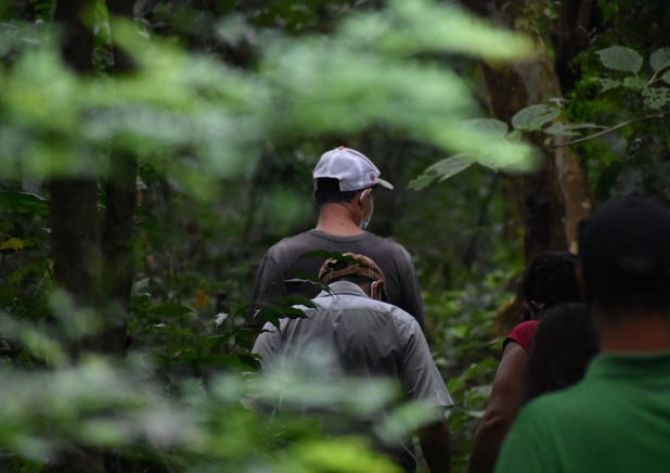 individual-from-a-church-walking-with-community-members-through-forest-and-building-relationships-